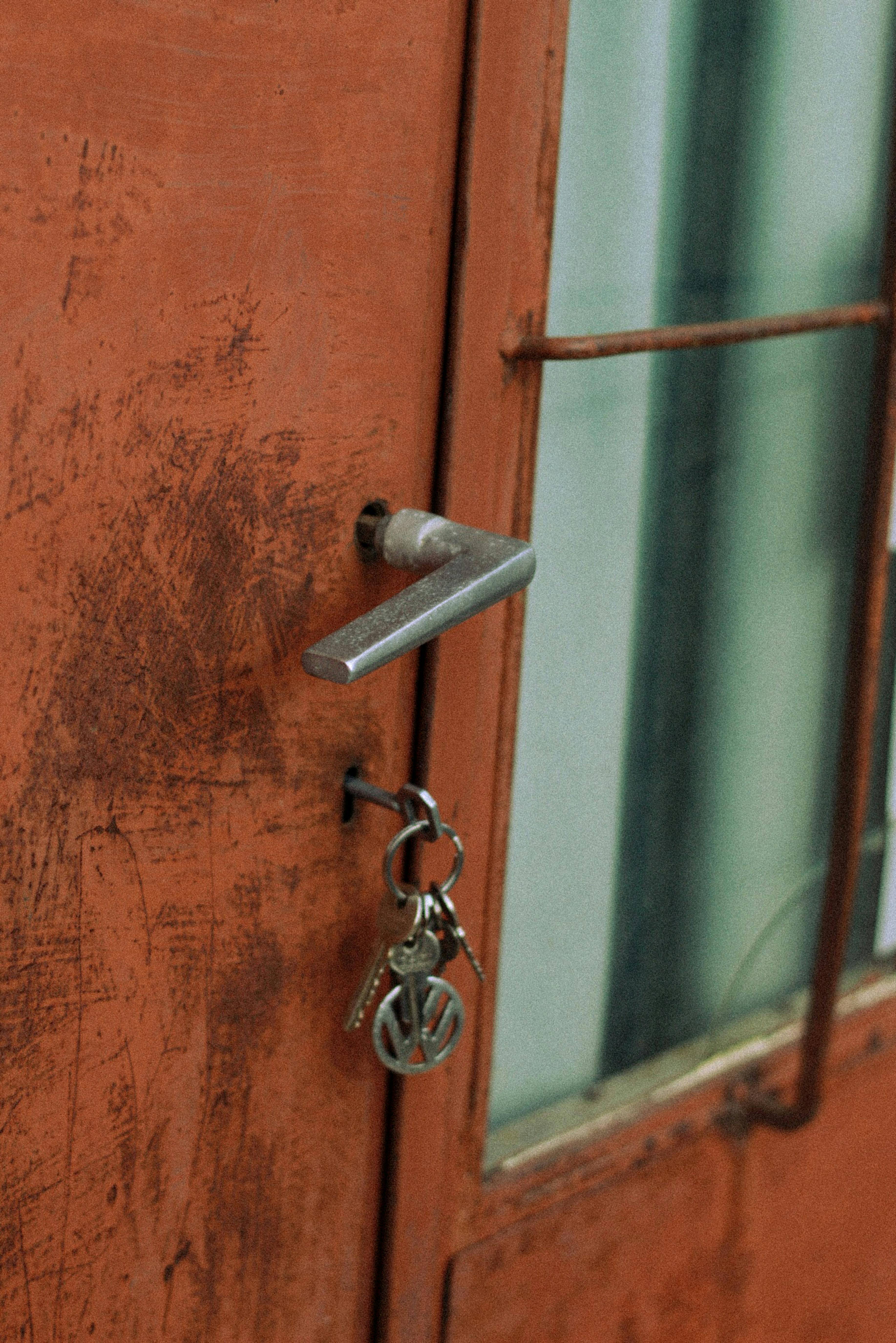 Keys hanging from orange door handle